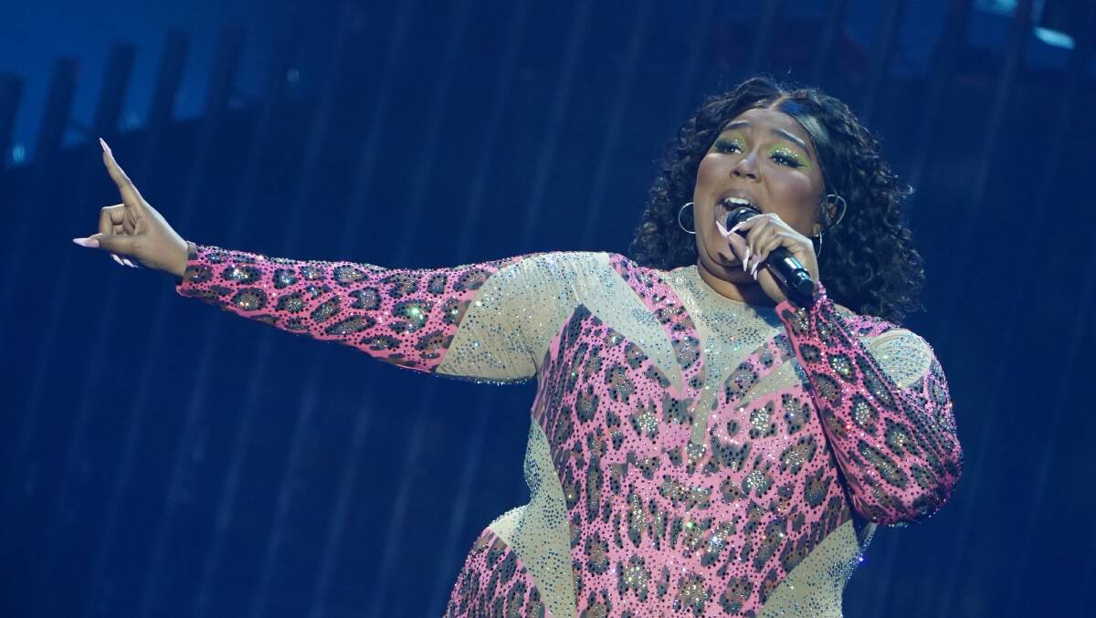 20 February 2023, Hamburg: US singer Lizzo performs on stage at Barclays Arena during her concert. Picture by Marcus Brandt/dpa