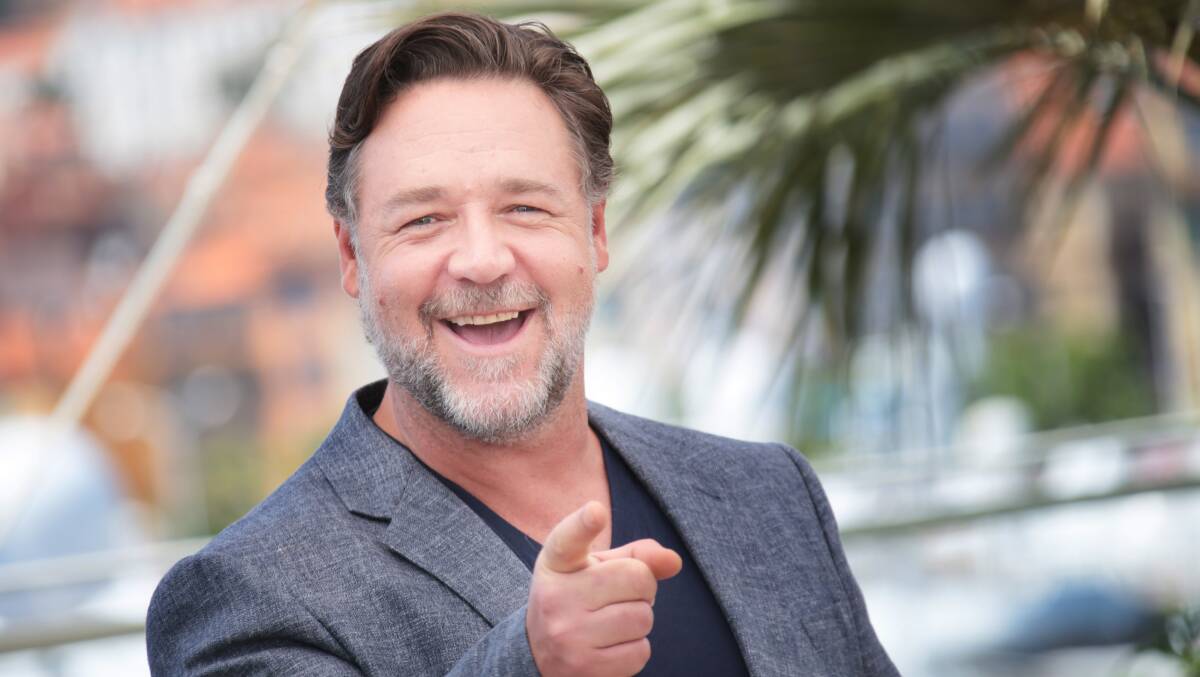 Russell Crowe points and laughs at the camera. Picture via Shutterstock