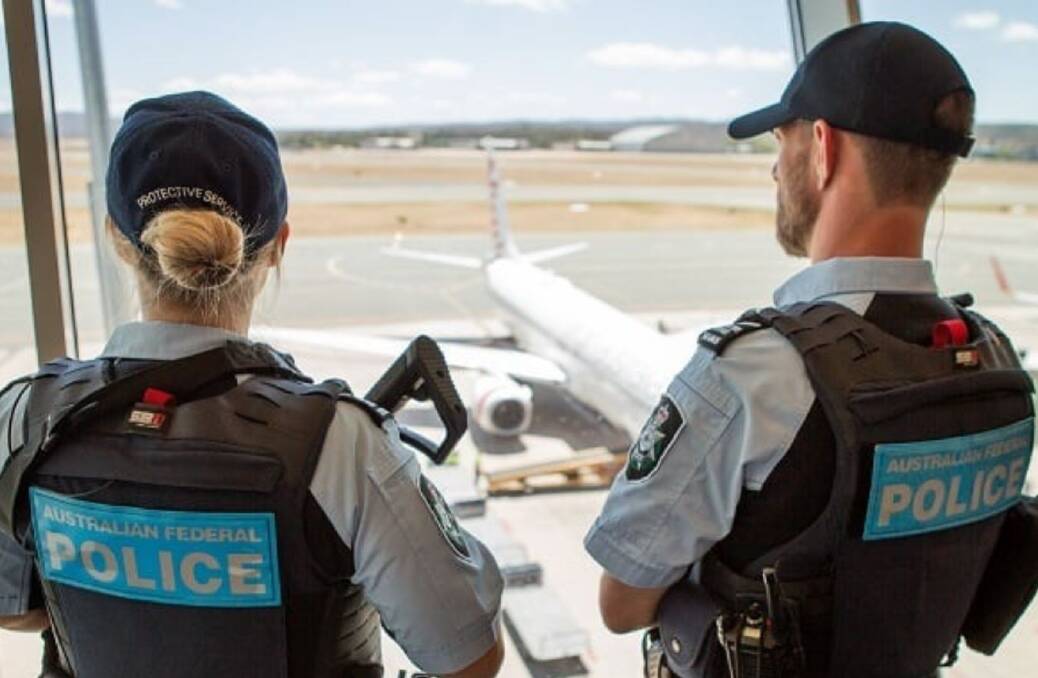Australian Federal Police officers patrol an airport. Picture AFP