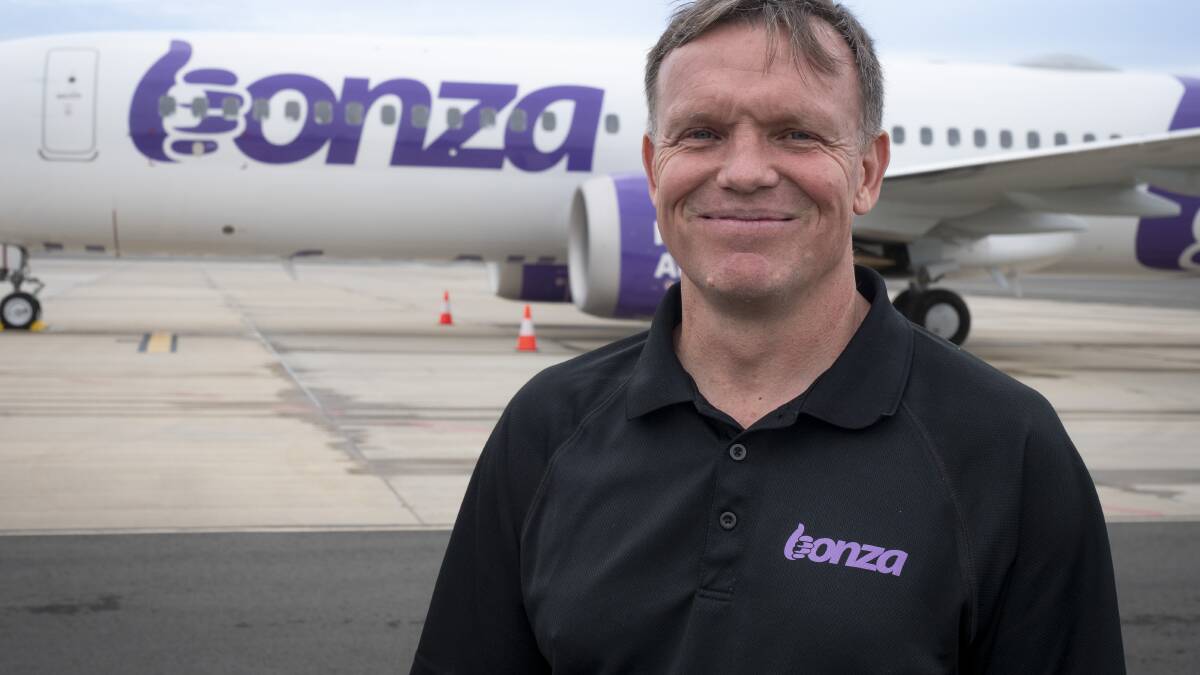 Bonza CEO Tim Jordan standing in front of a branded plane. Picture by Bonza