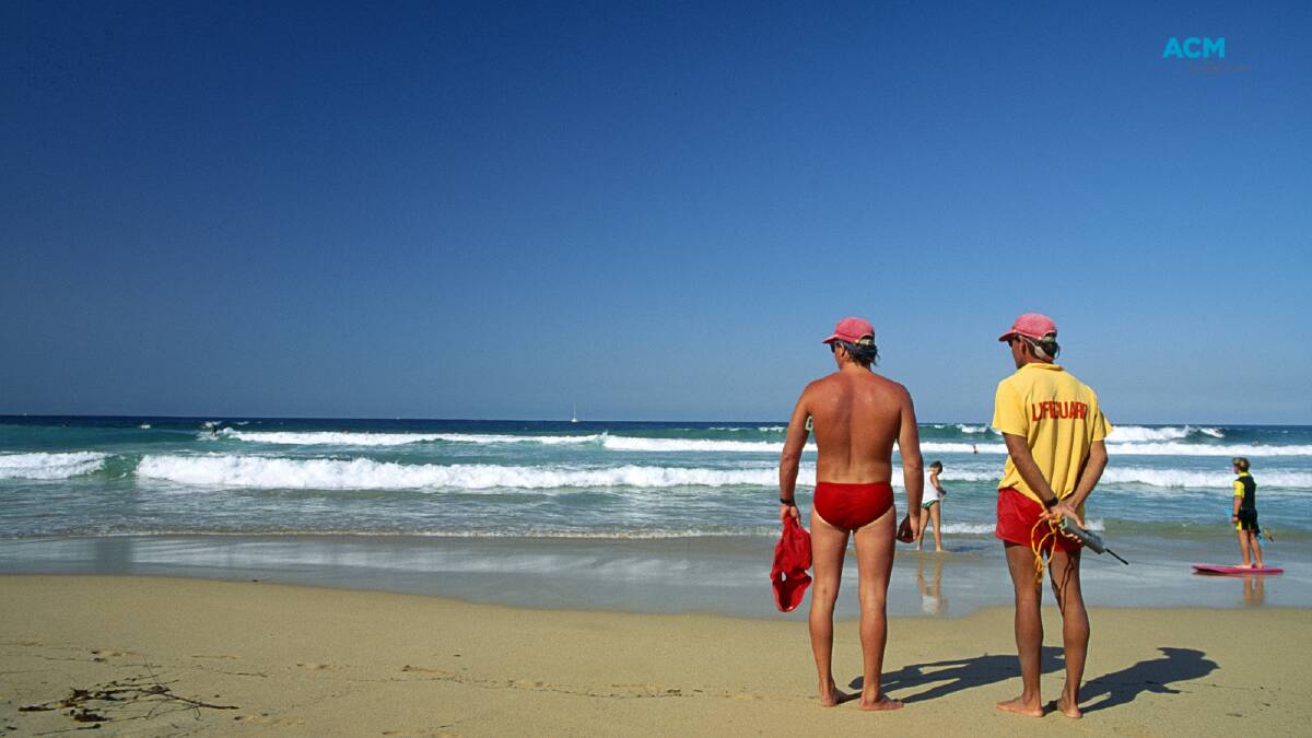Two surf lifesavers looking over the beach on a clear, sunny day. File picture.