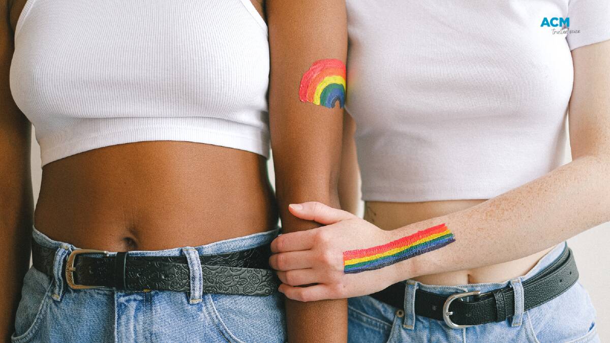 Women with LGBTQIA+ rainbows painted on their arms. Picture by Anna Shvets via Canva