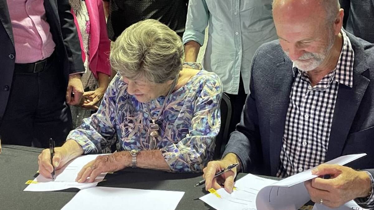Joy McKean and David Kirkpatrick, Slim Dusty's widow and son, sign the final papers to transfer ownership of the Slim Dusty Centre to Kempsey Shire Council in late 2022. Picture by Ellie Chamberlain