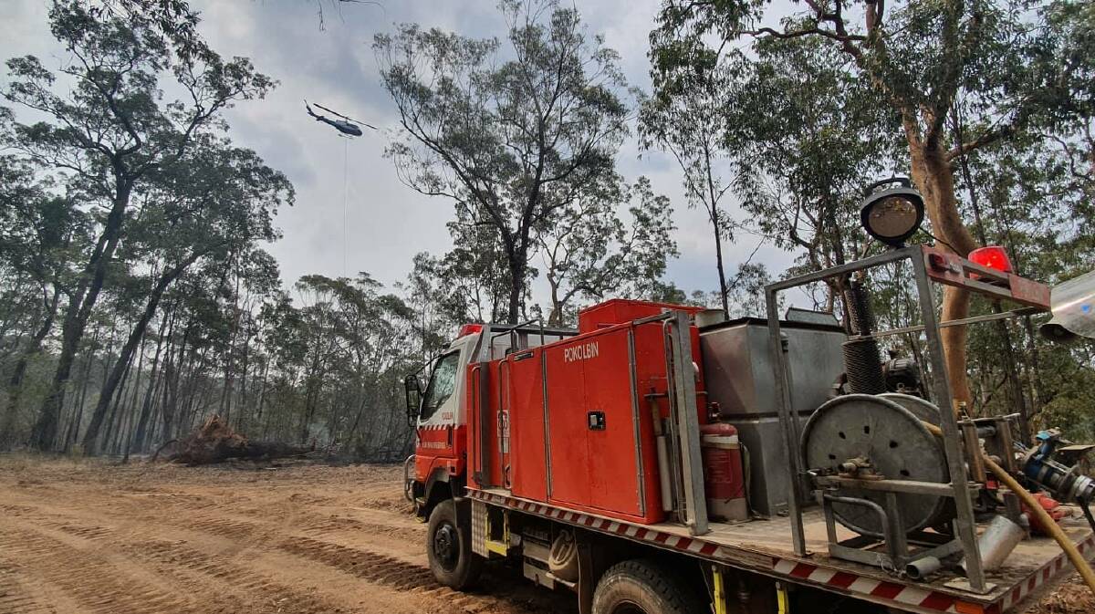 CONTAINED: Firefighting aircraft assists the Pokolbin Rural Fire Brigade at the Owendale fire near Broke. Picture: Lewis Drayton