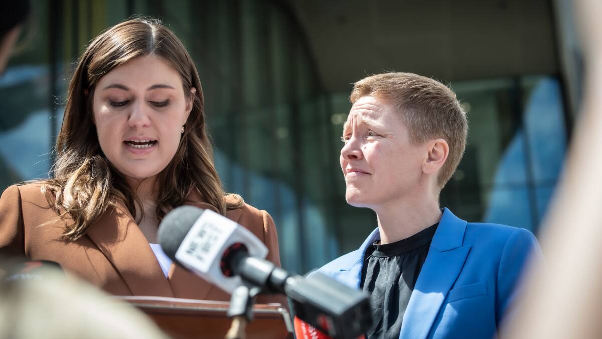 Brittany Higgins, left, speaks after Bruce Lehrmann's mistrial last year as Victims of Crime Commissioner Heidi Yates, right, looks on. Picture by Karleen Minney