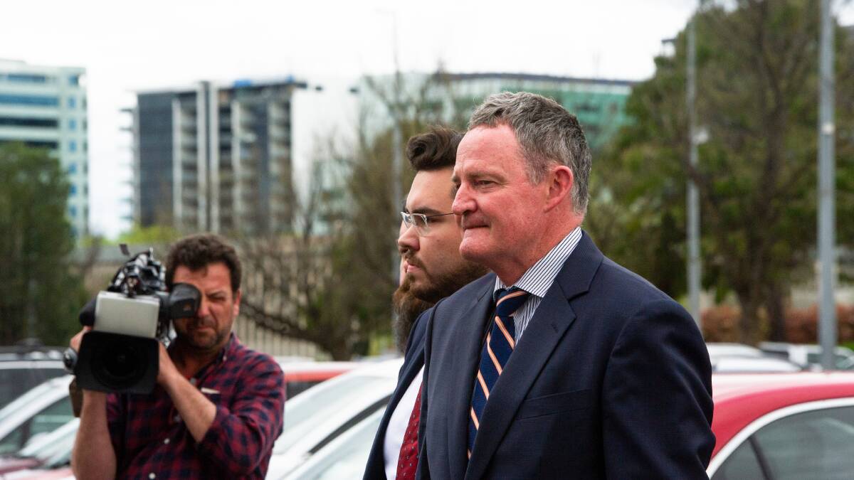 Defence barrister Steven Whybrow leaves court with Bruce Lehrmann on Thursday. Picture by Elesa Kurtz