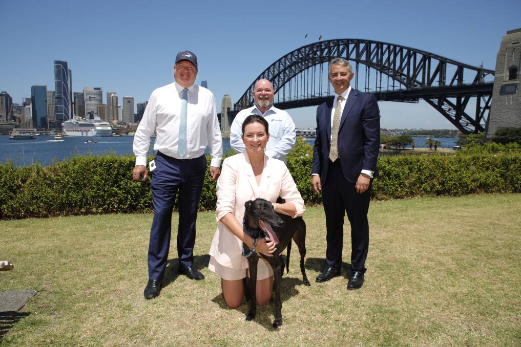 Megan Parker and her adopted greyhound Frank with (from left) GRNSW CEO Rob Macaulay, PANSW President Kevin Morton and GA Chairman Robert Vellar. Picture by Ross Schultz
