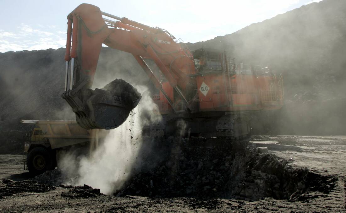 DIRT AND DUST: Excavator operating at the Bloomfield open-cut coalmine at Ashtonfield. Picture: Stuart Quinn