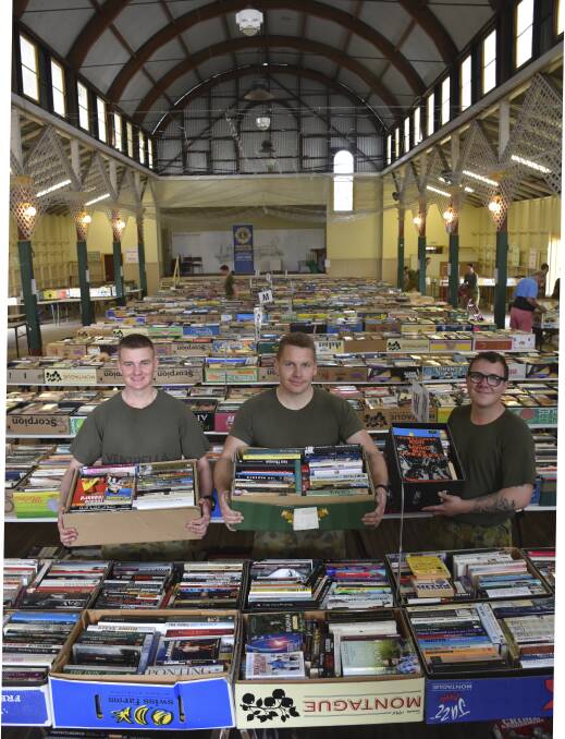 HELPING HAND: Singleton's Lone Pine Barracks soldiers Daniel Ventrella, Jake Eliis and Brenden Falconer were on-hand Tuesday morning to assist with the set-up for the annual Lions Club Book Fair.