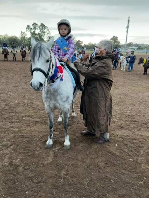 NEW SKILLS: One of the younger members of the Merriwa Pony Club receives their ribbon.