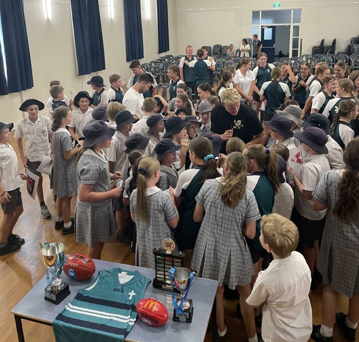 Swan's Issac Heeney and GWS's Toby Greene busy signing autographs at St Catherine's Catholic College.