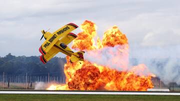 Paul Bennett puts on a spectacular appearance at the Hunter Valley Airshow accompanied by explosions. Picture by Peter Lorimer