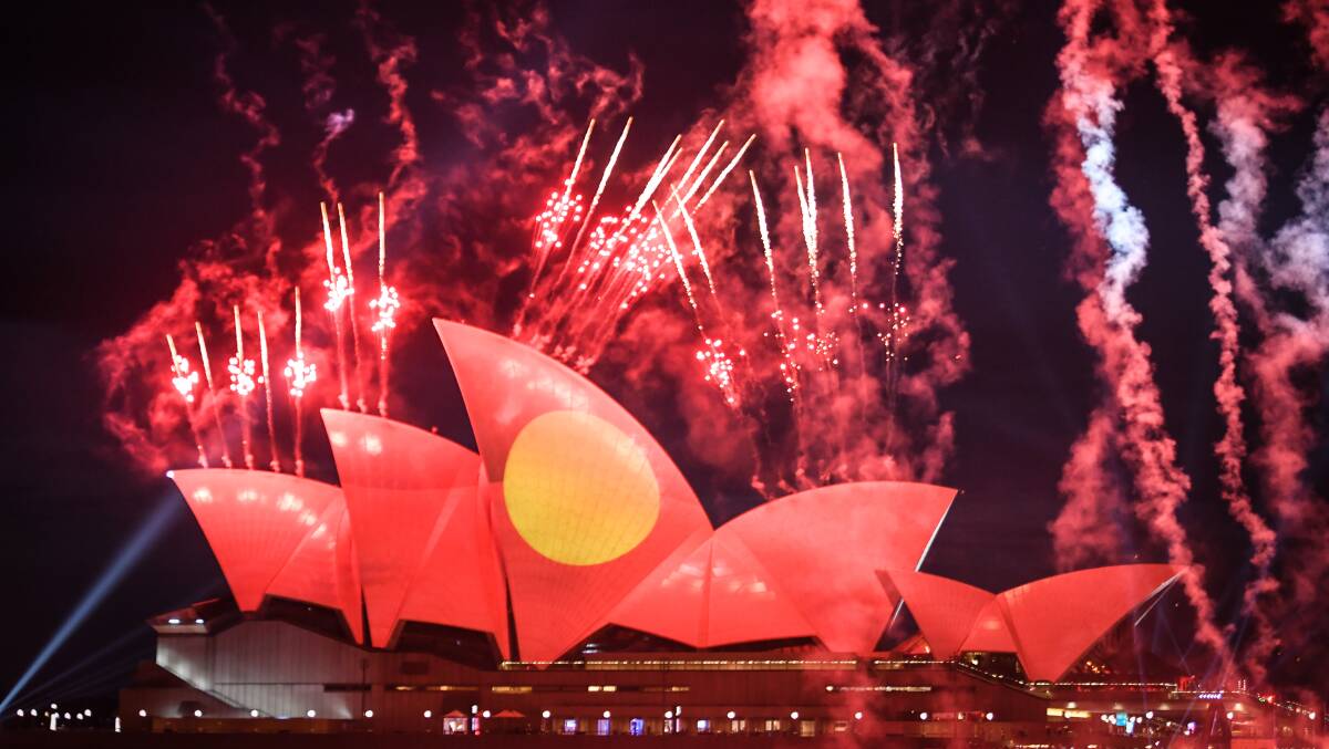 The Aboriginal flag is projected onto the Sydney Opera House during Australia Day celebrations. Picture Getty Images