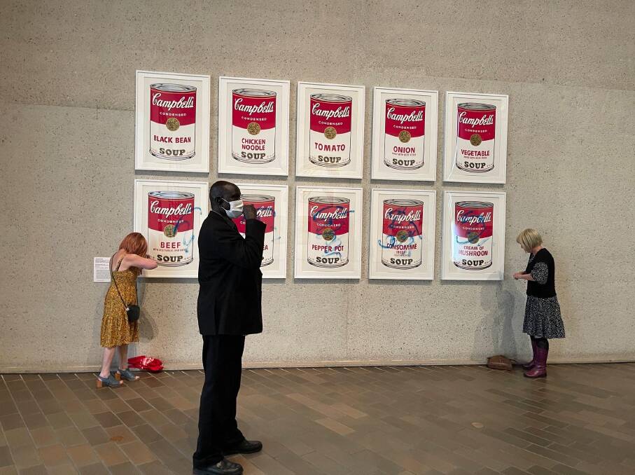 Protesters spray graffiti across Andy Warhol's Campbell's Soup Cans at the National Gallery of Australia, November 9, 2022. Picture: Supplied