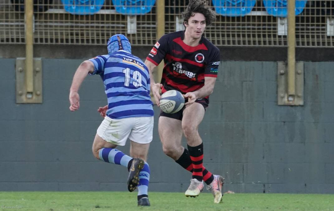 WING AND A PRAYER: Teenage sensation Ethan McGloughlin gets a pass away under pressure in the Bulls' come from behind 36-22 win over Wanderers. Picture: Matt Mockovic (NBN News)