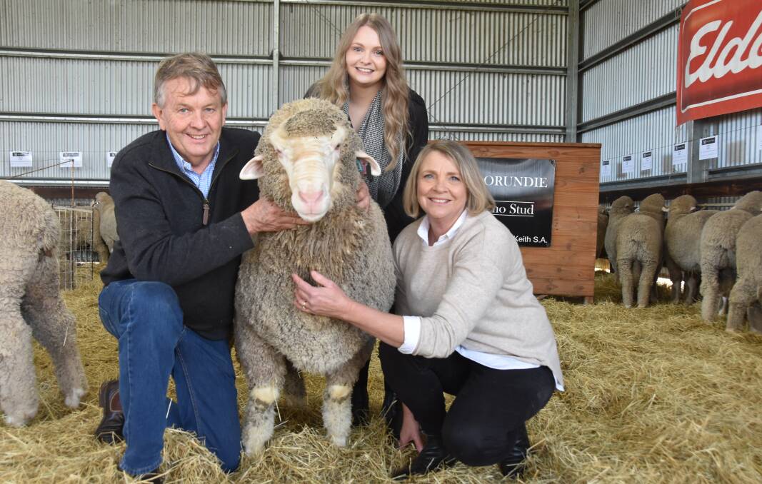 Geoff and Bernadette Davidson and their daughter Sarah, Moorundie Poll, Keith, SA, with their lot 4 ram, which made $58,000. Photo: CATHERINE MILLER