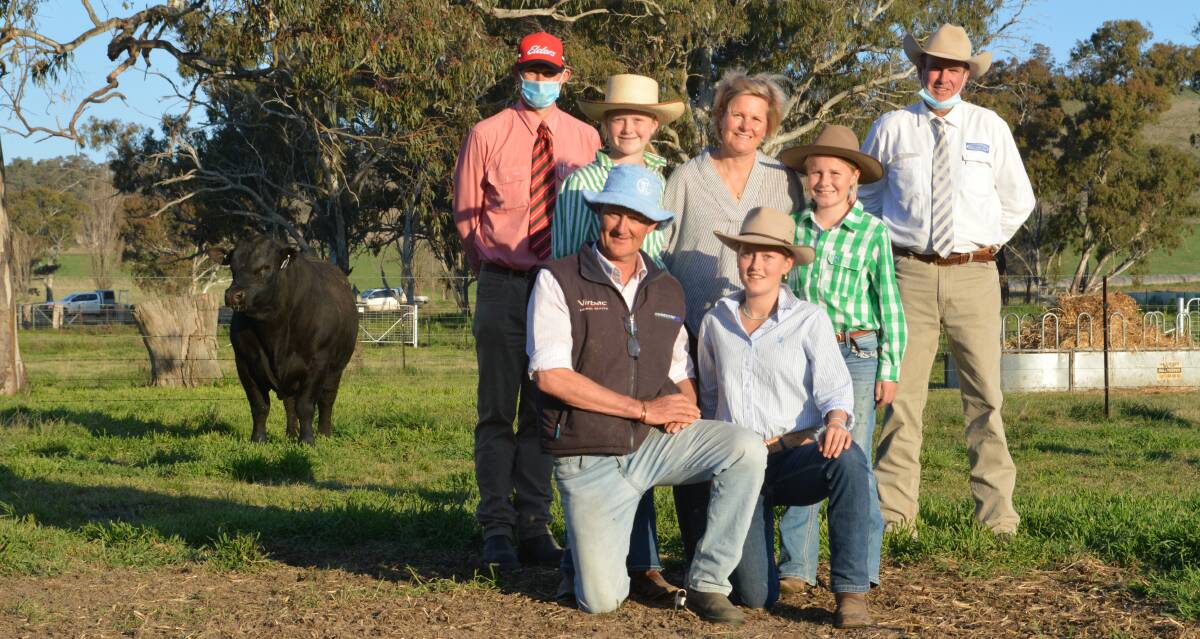 The $280,000 Australian Angus record top-priced bull with Elders agent Andrew Bickford, Bathurst, auctioneer Paul Dooley, Tamworth and Millah Murrah's Ross and Dimity Thompson and their daughters Millie, Olivia and Twiggy. Photo: HANNAH POWE