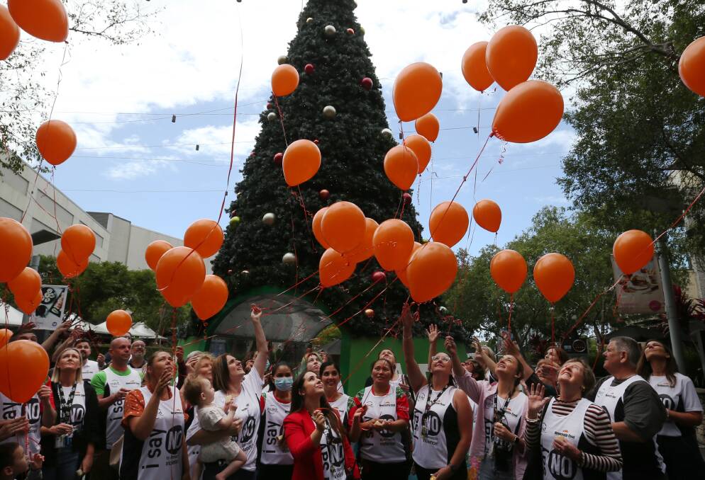 March attendees letting off balloons outside Charlestown Square to honour the 44 women killed by violence this year. Picture by Simone De Peak