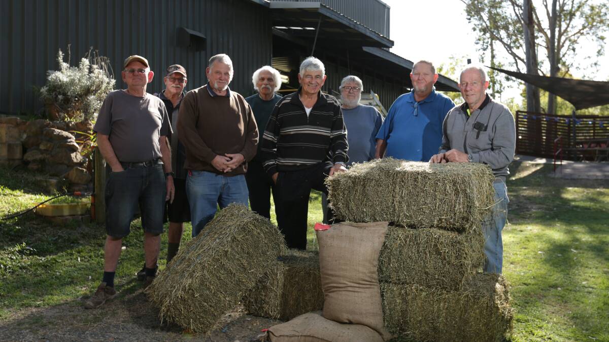 Maitland Community Men's Shed members with the first bales of hay and grain donated. Picture: Simone De Peak