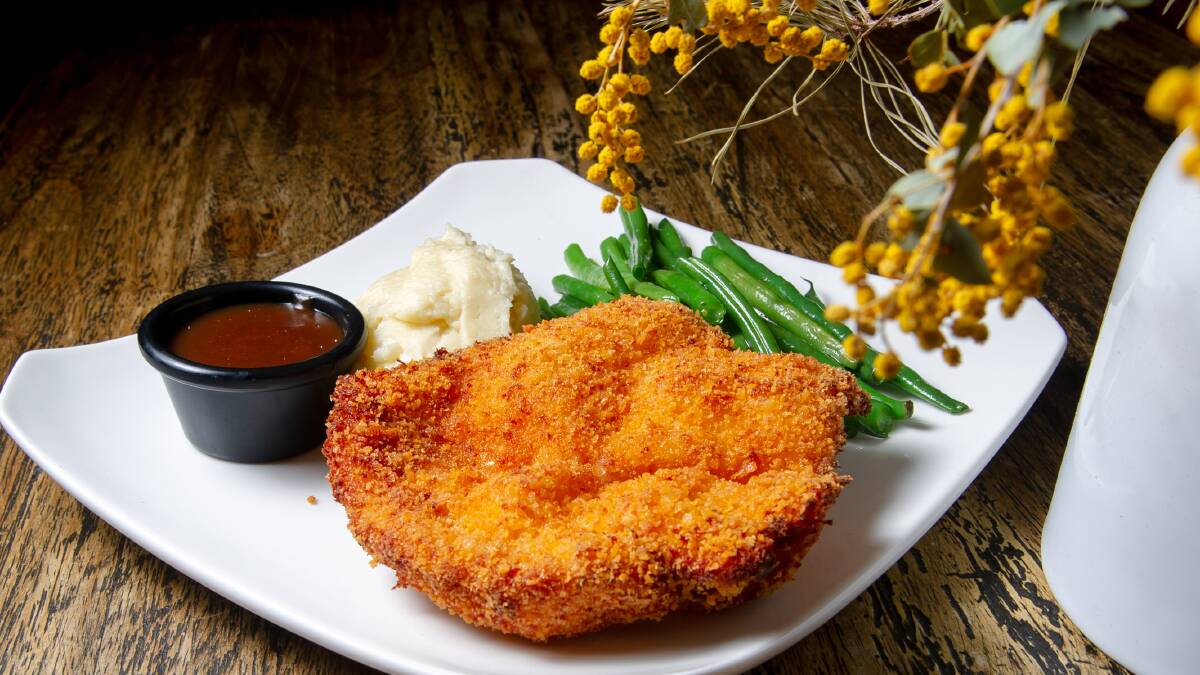 Is the Old Canberra Inn's schnitzel with garlic mash and beans Canberra's best? Picture by Elesa Kurtz