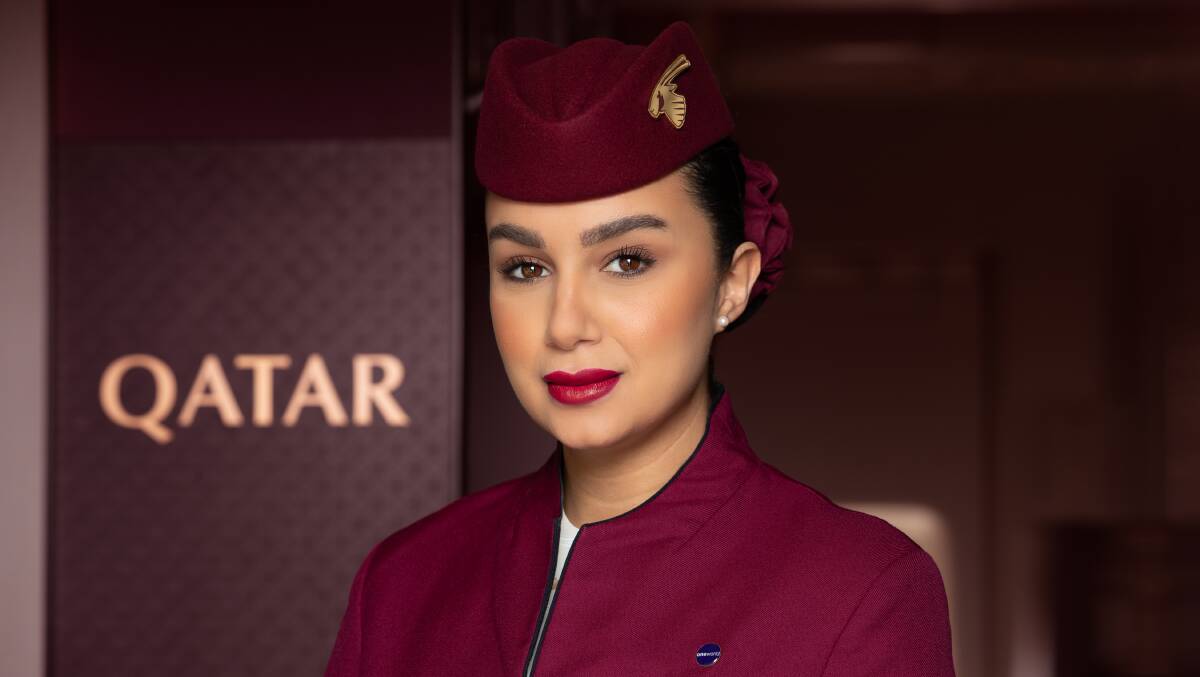 A Qatar Airways cabin crew member. A Qatar Airways cabin crew member.