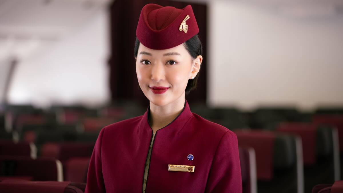 A Qatar Airways cabin crew member. A Qatar Airways cabin crew member.
