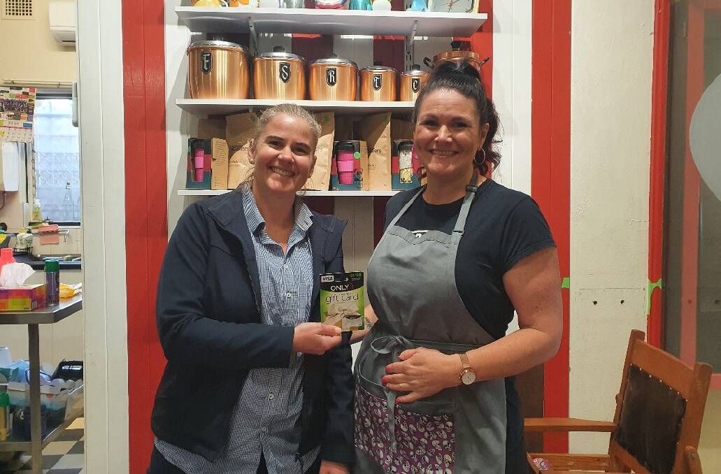 WINNER: Upper Hunter road safety officer Alison Balding presents the owner of Kashas Coffee Lounge in Muswellbrook, Jenn McFarlane, with a $200 gift card. 