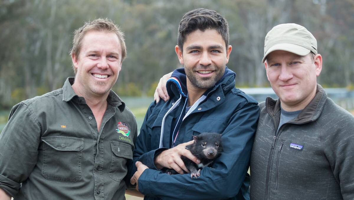 Tim Faulkner, Adrian Grenier and Wes Sechrest with a Tasmanian devil joey