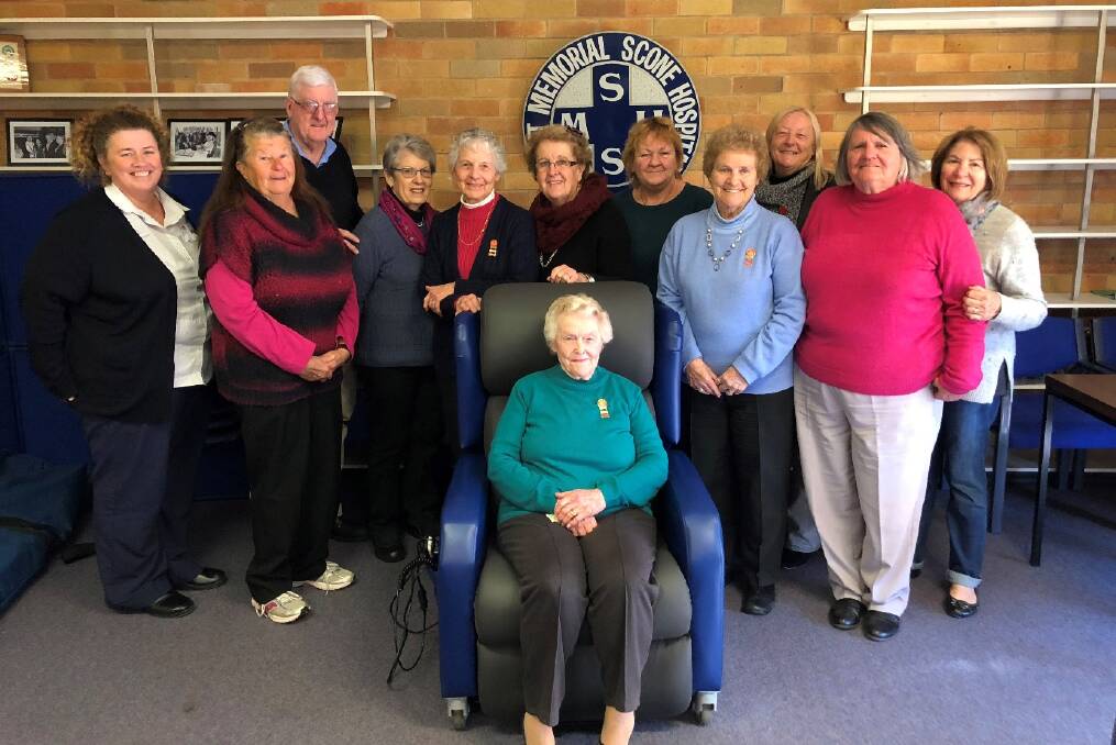 Acting Health Service manager Nicole Briggenshaw, Diane Pund, Phil and Stephanie McGuirk, Beryl Phelps, Helen Barwick, Sue Dalley, Shirley Spencer, Cathy Eveleigh, Sandra Graham, Jan Waters, Elaine Wicks (seated) test the new electric recliner purchased for Scott Memorial Hospital. Absent: Pat Dann, Margaret Cooper and Merna Mason