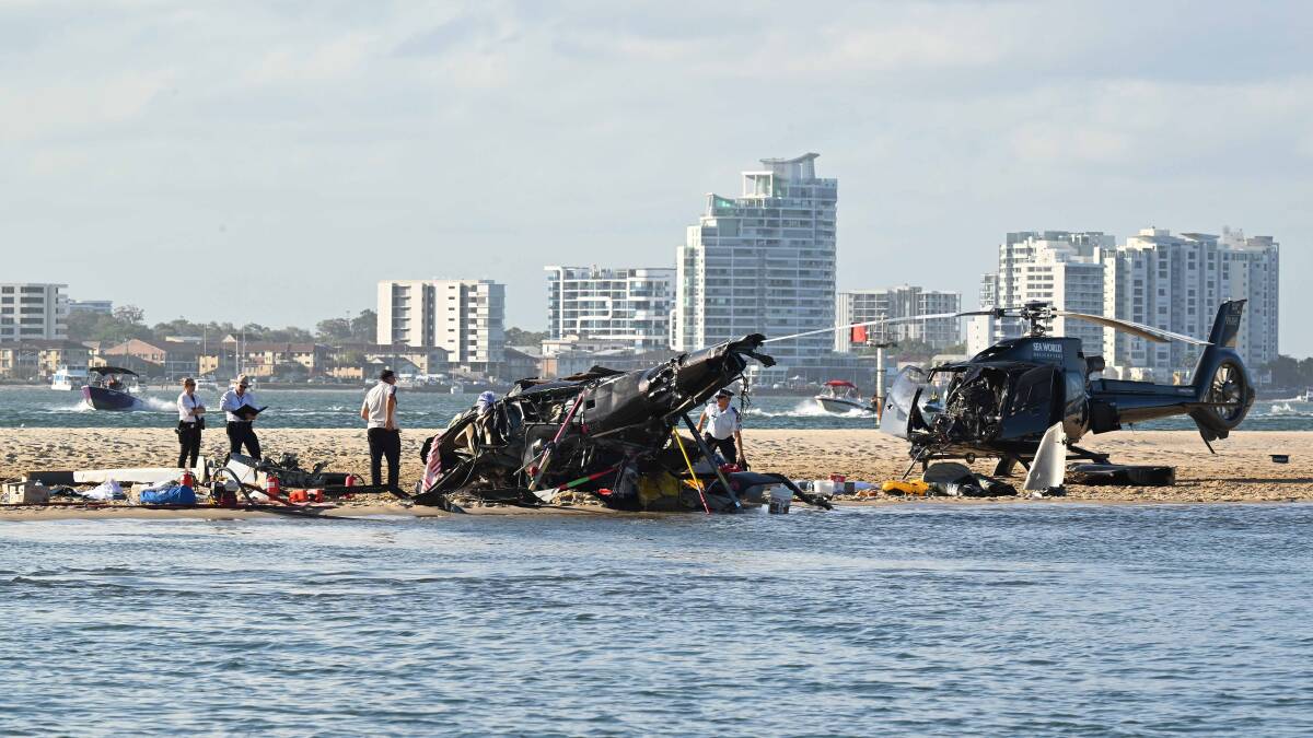 The wreckage of two helicopters are seen following a collision near Seaworld. Picture by AAP Image/Dave Hunt The wreckage of two helicopters are seen following a collision near Seaworld. Picture by AAP Image/Dave Hunt