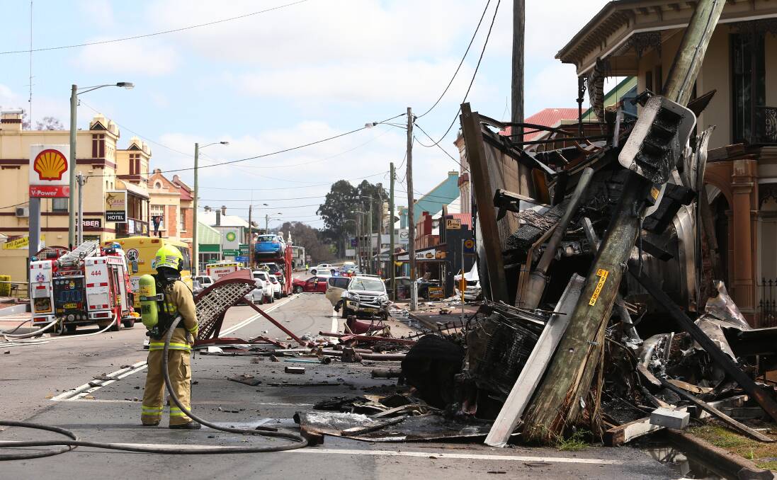 The scene of the truck crash in Singleton's main street outside the Royal Hotel, including Kerry Small's red car in the background.