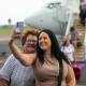 Sunshine Coast businesswoman Donna Niazov takes a selfie on the tarmac at Newcastle Airport after arriving on Tuesday. Picture by Jonathan Carroll 