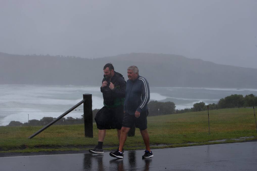 Mick Rigney and his father-in-law John Ingram on Friday, being battered by harsh wind and rain in his quest to walk 216 kilometres in four days (a distance and elevation equivalent to Mount Everest). Picture by Sylvia Liber.