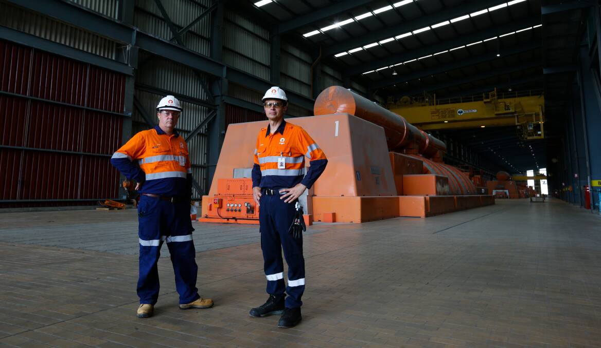 Origin External Affairs manager Paul Duboudin, left, and Antony Cotic, Eraring asset services manager, in the Eraring Power Station turbine hall. Picture by Jonathan Carroll.