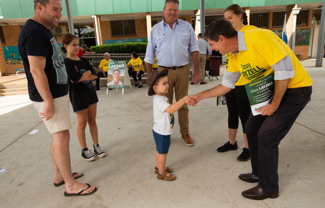 Dave Layzell meets one of the younger members of the community on Saturday. Picture by Jonathan Carroll. 