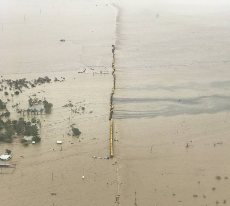 FLOODED: Aerial footage shows the derailed train in the middle of an inland sea near Nelia. Photo Queensland Rail