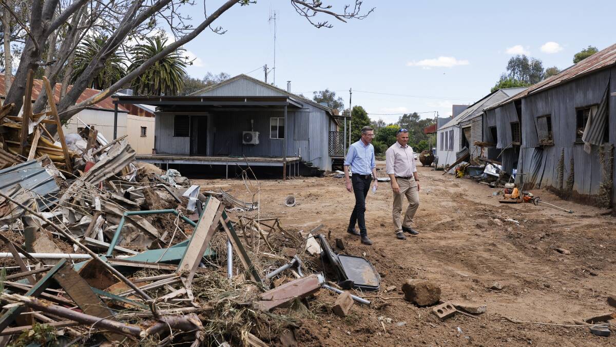 NSW Premier Dominic Perrottet and State Member for Orange Philip Donato walk through flood-damaged buildings in Eugowra. Picture Getty Images 