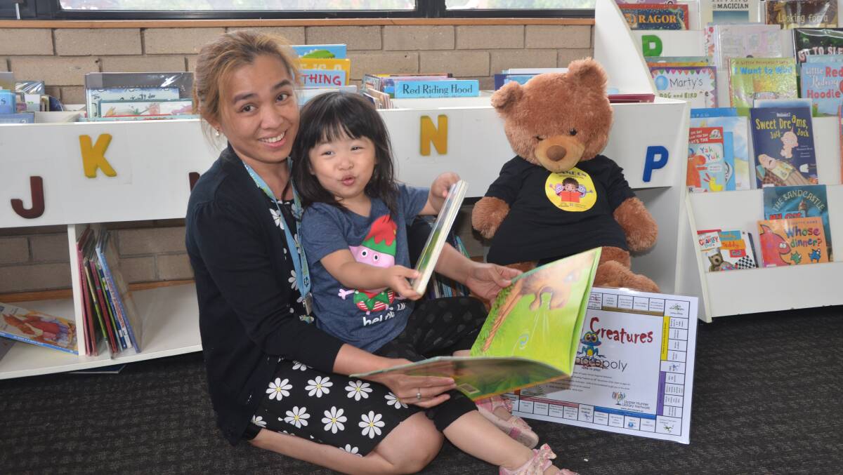 LOVE LEARNING: Muswellbrook Library's Angelynn Gill (left) is preparing to educate more children like Skylar Mak during the holidays.