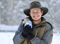 TASTE OF HOME: Aussie Ark keeper Tyler Gralton. The animals awoke to snow for the second time this year. Picture: Aussie Ark