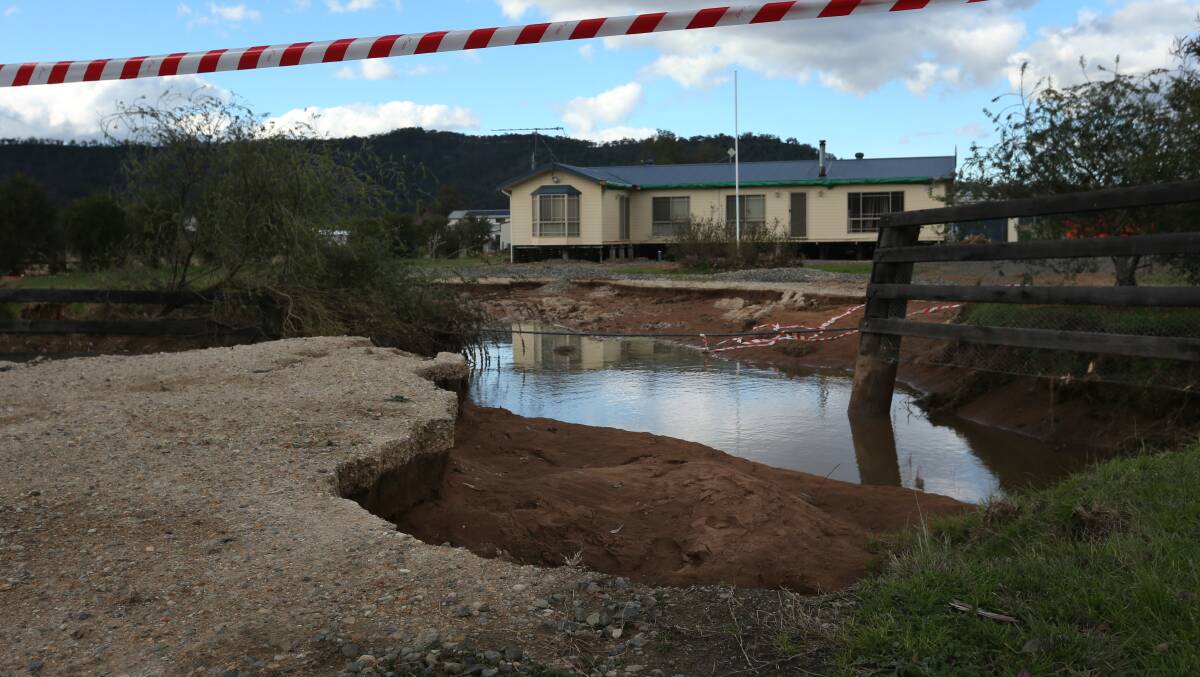 A sinkhole at Broke in July after heavy weather devastated the area. Picture by Simone De Peak