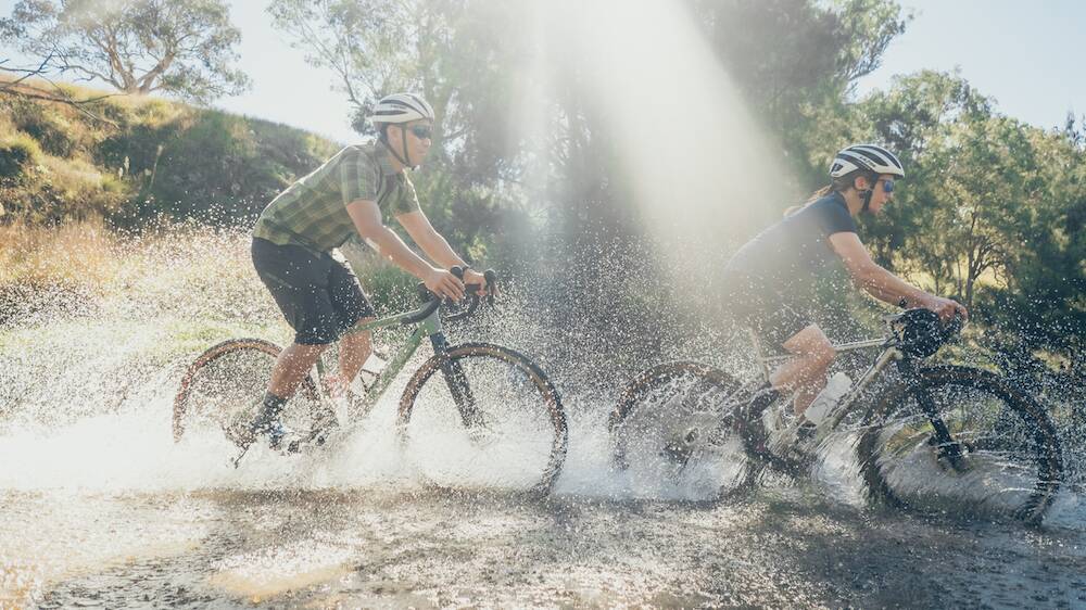 Taking on an adventurous creek crossing at Gundy Gravel Fondo cycling event in 2021. Pictures by Outerimage courtesy of goodnessgravel.