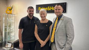 Raine & Horne Muswellbrook's owner and director Grant Jupe (on right) hands the reins over to Kurri Kurri's Carolyn Wallis-Tomlins and Ryan Mitchell. Photo supplied.
