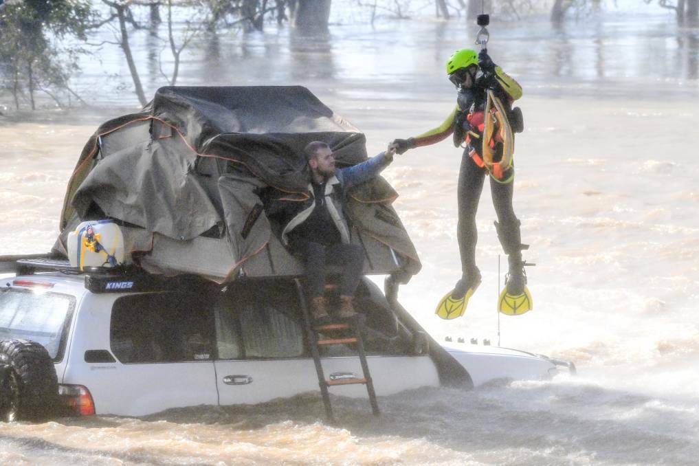 The Victoria State Emergency Service (SES) comes to the rescue of campers stranded on their car by floodwaters at Newbridge near Bendigo in October, 2022. Picture by Darren Howe