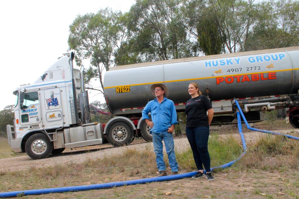 EFFORTS: Bob Walton and Kylie Cross with the tanker used to pump water.

