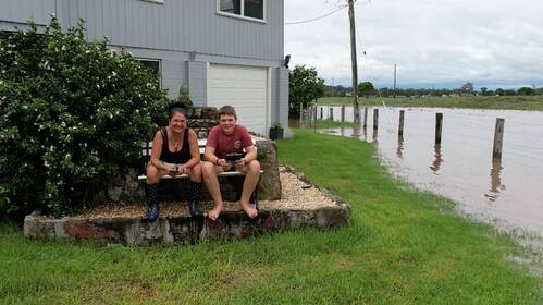 Michelle Bryant and son Jacob Merrick, 13, surrounded by water on their Combo Lane property. Picture: Jacob Merrick / Hunter Valley Photography & Videography