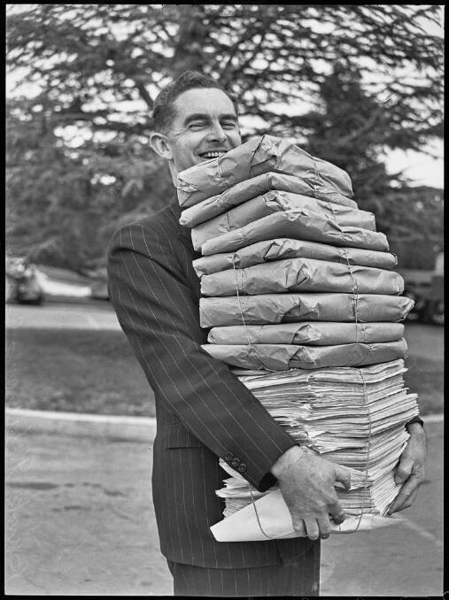 A bank officer delivers protest petitions to Parliament House in September 1947. Picture: State Library of NSW