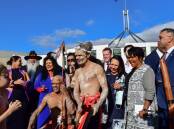 Performers and MPs outside Parliament House after a welcome to country ceremony in Canberra. Picture by Elesa Kurtz
