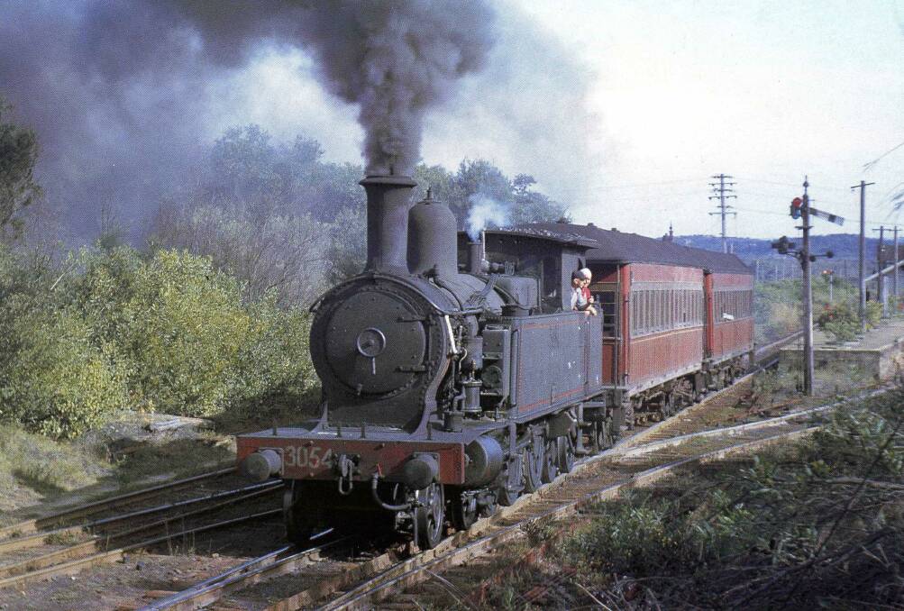 ALL ABOARD: A steam train pulling passenger carriages leaves Redhead station in 1963. Picture: Courtesy, Ray Love 