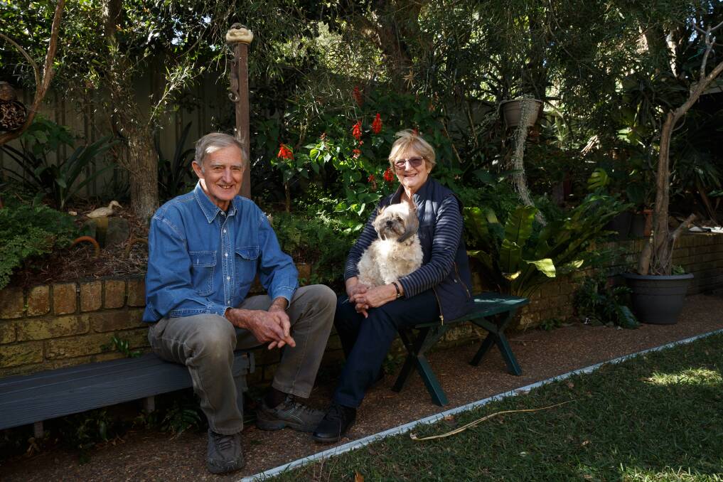 John and Pam Le Messurier, with their dog Miss Molly, in their Redhead backyard in 2019. Picture: Max Mason-Hubers 