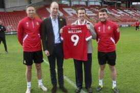 Hollywood star Rob McElhenney presents a special Wrexham shirt to Prince William at the Welsh club. (AP PHOTO)